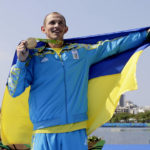 
              FILE - Ukraine's Yuri Cheban celebrates his gold in the men's canoe single 200m final during the 2016 Summer Olympics in Rio de Janeiro, on Aug. 18, 2016. Cheban, one of Ukraine's most decorated Olympians, told The Associated Press in an email exchange Wednesday, Nov. 30, 2022, that he is auctioning his medals — two golds and a bronze — in hopes of raising a six-figure donation to contribute to the war effort in his native land. (AP Photo/Matt York, File)
            