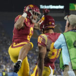 
              Southern California wide receiver Kyle Ford, center, celebrates his touchdown with running back Austin Jones during the second half of an NCAA college football game against UCLA Saturday, Nov. 19, 2022, in Pasadena, Calif. (AP Photo/Mark J. Terrill)
            