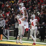 
              Ohio State running back Dallan Hayden (5) celebrates his touchdown with offensive lineman Luke Wypler (53), wide receiver Julian Fleming (4) and offensive lineman Donovan Jackson (74) during the second half of an NCAA college football game against Maryland, Saturday, Nov. 19, 2022, in College Park, Md. Ohio State won 43-30. (AP Photo/Nick Wass)
            