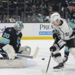 
              Seattle Kraken goaltender Martin Jones makes a save on a shot by Los Angeles Kings right wing Carl Grundstrom (91) as Kraken's Vince Dunn defends during the first period of an NHL hockey game Saturday, Nov. 19, 2022, in Seattle. (AP Photo/Jason Redmond)
            