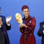 
              FILE - Sheikh Hamad bin Khalifa Al-Thani, Emir of Qatar, left, and FIFA President Joseph Blatter, right, applaud, as Sheika Mozah bint Nasser al-Misned holds the World Cup trophy, after the announcement of Qatar hosting the 2022 soccer World Cup in Zurich, Switzerland, Thursday, Dec. 2, 2010. Hosting the World Cup marks a pinnacle in Qatar's efforts to rise out of the shadow of its larger neighbors in the wider Middle East. (AP Photo/Michael Probst, File)
            