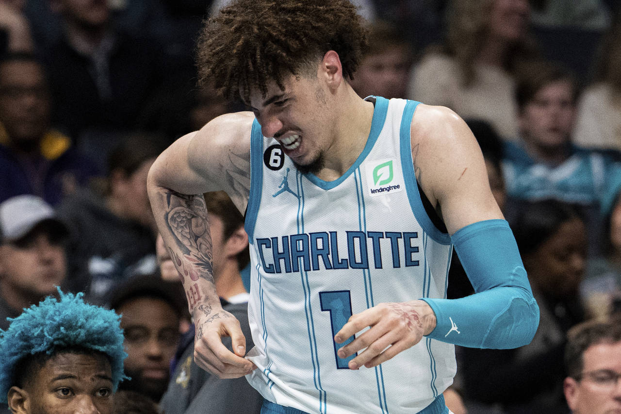 Charlotte Hornets guard LaMelo Ball reacts after being shaken up on a play during the second half o...
