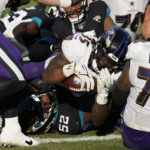 
              Baltimore Ravens running back Gus Edwards (35) scores a touchdown against Jacksonville Jaguars defensive tackle DaVon Hamilton (52) during the second half of an NFL football game, Sunday, Nov. 27, 2022, in Jacksonville, Fla. (AP Photo/John Raoux)
            