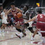 
              San Diego State guard Darrion Trammell, second from right, drives to the basket between Stanford forward Spencer Jones (14) and guard Michael O'Connell (5) during the first half of an NCAA college basketball game in Stanford, Calif., Tuesday, Nov. 15, 2022. (AP Photo/Godofredo A. Vásquez)
            