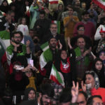 
              Iranian fans watch their national soccer team play against the United States in Qatar's soccer World Cup on a giant screen at a cultural center in Tehran, Iran, Tuesday, Nov. 29, 2022. (AP Photo/Vahid Salemi)
            