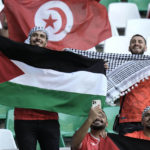
              A soccer supporter waves a flag of Palastine before the start of the World Cup group D soccer match between Denmark and Tunisia, at the Education City Stadium in Al Rayyan , Qatar, Tuesday, Nov. 22, 2022. (AP Photo/Hassan Ammar)
            