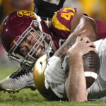
              Notre Dame quarterback Drew Pyne, right, is sacked by Southern California defensive lineman Stanley Ta'ufo'ou during the first half of an NCAA college football game Saturday, Nov. 26, 2022, in Los Angeles. (AP Photo/Mark J. Terrill)
            