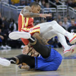 
              Atlanta Hawks guard Dejounte Murray lands on top of Orlando Magic guard Markelle Fultz while going for a loose ball during the first half of an NBA basketball game Wednesday, Nov. 30, 2022, in Orlando, Fla. (AP Photo/Phelan M. Ebenhack)
            