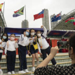 
              A student group poses for a photograph in front of the Hong Kong Stadium ahead of the first day of the Hong Kong Sevens rugby tournament in Hong Kong, Friday, Nov. 4, 2022. Revelers returned to Hong Kong Stadium on Friday to enjoy a highly-anticipated international rugby tournament for the first time since the COVID-19 crisis began, but some international fans unaware of the city's pandemic restrictions were being turned away at the gate. (AP Photo/Anthony Kwan)
            