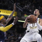 
              Indiana Pacers' Tyrese Haliburton (0) puts up a shot against Denver Nuggets' Kentavious Caldwell-Pope (5) during the second half of an NBA basketball game, Wednesday, Nov. 9, 2022, in Indianapolis. Denver won 122-119. (AP Photo/Darron Cummings)
            