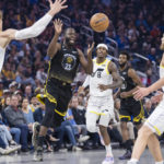 
              Golden State Warriors forward Draymond Green, second from left, passes the ball past Utah Jazz forward Lauri Markkanen, left, and forward Kelly Olynyk (41) during the first half of an NBA basketball game in San Francisco, Friday, Nov. 25, 2022. (AP Photo/John Hefti)
            