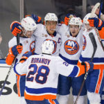 
              New York Islanders' Anders Lee (27) celebrates with Mathew Barzal, Noah Dobson (8), Oliver Wahlstrom (26) and Alexander Romanov (28) after scoring the game winning goal during the third period of an NHL hockey game against the New York Rangers Tuesday, Nov. 8, 2022, in New York. The Islanders won 4-3. (AP Photo/Frank Franklin II)
            