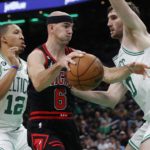 
              Boston Celtics' Grant Williams (12) and Luke Kornet, right, double-team Chicago Bulls' Alex Caruso (6) during the first half of an NBA basketball game, Friday, Nov 4, 2022, in Boston. (AP Photo/Michael Dwyer)
            