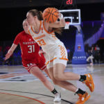 
              In this photo provided by Bahamas Visual Services, Tennessee's Marta Suarez (33) handles the ball against Rutgers' Abby Streeter (31) during an NCAA college basketball game in the Battle 4 Atlantis, Saturday, Nov. 19, 2022, at Atlantis in Paradise Island, Bahamas. (Tim Aylen/Bahamas Visual Services via AP)
            