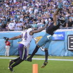 
              Jacksonville Jaguars wide receiver Marvin Jones Jr. (11) makes a touchdown catch against Baltimore Ravens cornerback Marcus Peters (24) during the second half of an NFL football game, Sunday, Nov. 27, 2022, in Jacksonville, Fla. (AP Photo/Phelan M. Ebenhack)
            