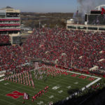 
              The Nebraska football team enters the field as the marching band and cheerleaders perform before playing against Minnesota in an NCAA college football game at Memorial Stadium on Saturday, Nov. 5, 2022, in Lincoln, Neb. College athletic programs of all sizes are reacting to inflation the same way as everyone else. They're looking for ways to save. (AP Photo/Rebecca S. Gratz)
            