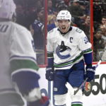 
              Vancouver Canucks center Bo Horvat (53) celebrates his second goal of the game against the Ottawa Senators during the third period of an NHL hockey game, Tuesday, Nov. 8, 2022 in Ottawa, Ontario. (Justin Tang/The Canadian Press via AP)
            