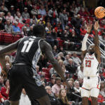 
              Texas Tech guard De'Vion Harmon (23), right, shoots the ball against Georgetown during an NCAA college basketball game,  Wednesday, Nov. 30, 2022, at United Supermarkets Arena in Lubbock, Texas. (Annie Rice/Lubbock Avalanche-Journal via AP)
            