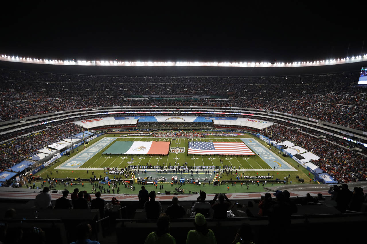 FILE -  The flags of Mexico and the United States cover the field before an NFL football game betwe...