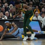 
              Marquette's Chase Ross and Baylor's Dale Bonner go after a loose ball during the first half of an NCAA basketball game Tuesday, Nov. 29, 2022, in Milwaukee. (AP Photo/Morry Gash)
            