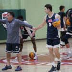 
              Jimmer Fredette, right, takes instruction from coach Fran Fraschilla, left, during practice for the USA Basketball 3x3 national team, Monday, Oct. 31, 2022, in Miami Lakes, Fla. (AP Photo/Lynne Sladky)
            