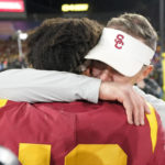 
              Southern California quarterback Caleb Williams, left, gets a hug from head coach Lincoln Riley after USC defeated UCLA 48-45 in an NCAA college football game Saturday, Nov. 19, 2022, in Pasadena, Calif. (AP Photo/Mark J. Terrill)
            