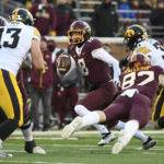 
              Minnesota quarterback Athan Kaliakmanis (8) scrambles to get away from Iowa defensive back Cooper DeJean (3) during the first half an NCAA college football game on Saturday, Nov. 19, 2022, in Minneapolis. (AP Photo/Craig Lassig)
            