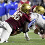 
              Duke quarterback Riley Leonard is tackled by Boston College defensemen, including Cam Horsley (96), during the second half of an NCAA college football game Friday, Nov. 4, 2022, in Boston. (AP Photo/Mark Stockwell)
            