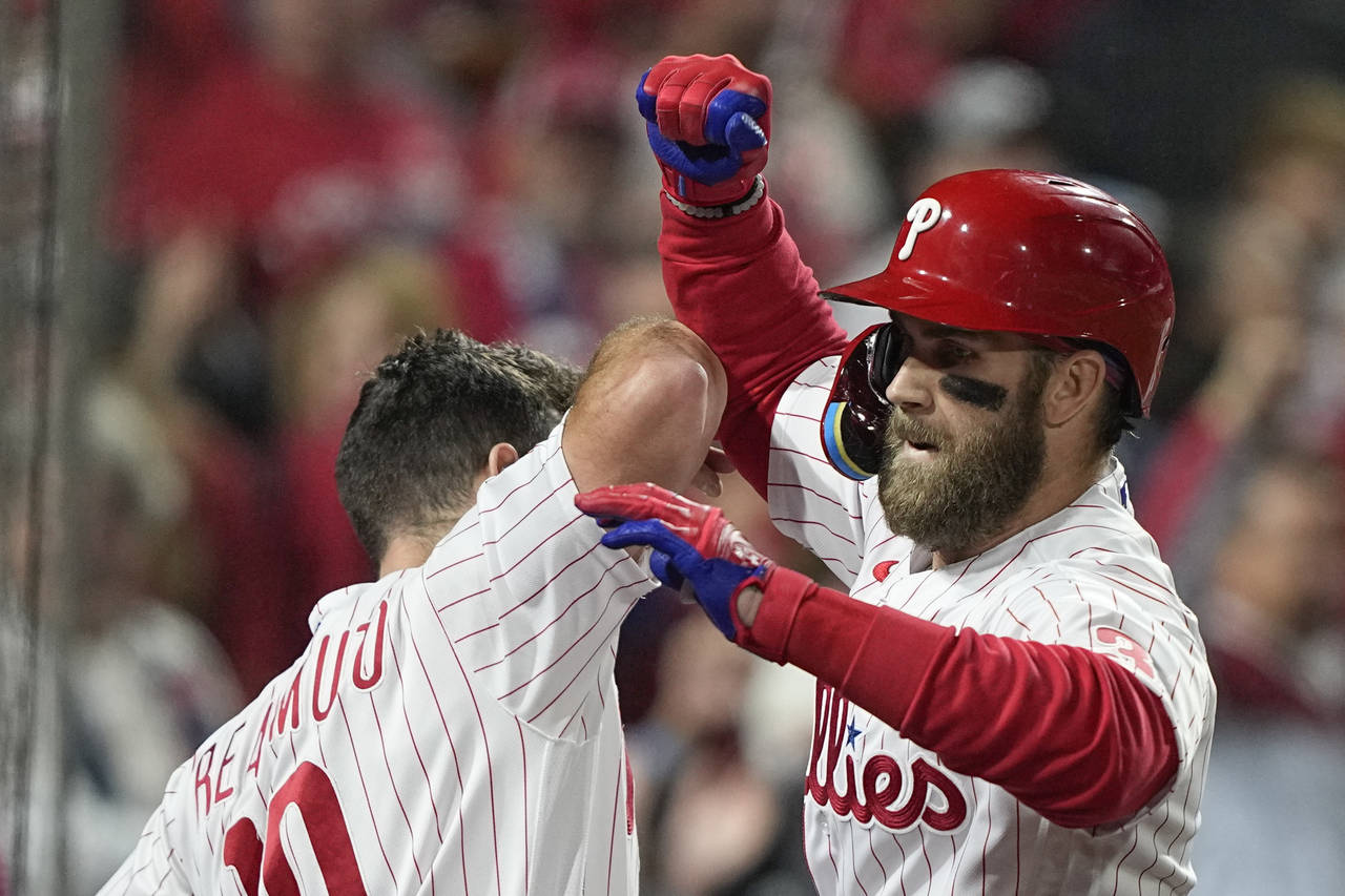 Philadelphia Phillies' Bryce Harper celebrates his two-run home run during the first inning in Game...