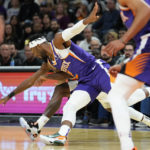 
              Phoenix Suns forward Josh Okogie (2) and Portland Trail Blazers forward Justise Winslow chase down a loose ball during the first half of an NBA basketball game, Saturday, Nov. 5, 2022, in Phoenix. (AP Photo/Matt York)
            