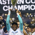 
              Philadelphia Union's Andre Blake raises the trophy after defeating New York City FC in an MLS soccer match, Sunday, Oct. 30, 2022, in Chester, Pa. The Union won 3-1 and clinched the MLS Eastern Conference title. (AP Photo/Chris Szagola)
            