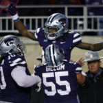 
              Kansas State wide receiver Malik Knowles, top, celebrates with linemen KT Leveston (70) and Hayden Gillum (55) after scoring a touchdown during the first quarter of the team's NCAA college football game against Kansas on Saturday, Nov. 26, 2022, in Manhattan, Kan. (AP Photo/Colin E. Braley)
            