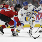 
              Buffalo Sabres right wing Alex Tuch (89) and New Jersey Devils defenseman Jonas Siegenthaler (71) go after the puck during the first period of an NHL hockey game Friday, Nov. 25, 2022, in Buffalo, N.Y. (AP Photo/Joshua Bessex)
            
