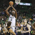 
              Baylor forward Flo Thamba (0) is called for an offensive foul while driving on Northern Colorado guard Caleb Shaw (30), Theo Hughes (32) and Bryce Kennedy (21) in the first half of an NCAA college basketball game, Monday, Nov. 14, 2022, in Waco, Texas. (AP Photo/Rod Aydelotte)
            