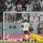 
              Poland's goalkeeper Wojciech Szczesny saves a penalty kick by Saudi Arabia's Salem Al-Dawsari during the World Cup group C soccer match between Poland and Saudi Arabia, at the Education City Stadium in Al Rayyan , Qatar, Saturday, Nov. 26, 2022. (AP Photo/Darko Vojinovic)
            