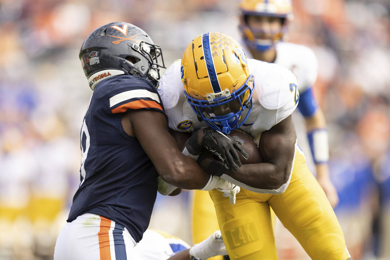 Pittsburgh's Israel Abanikanda (2) fights to keep the ball against Virginia during the first half o...
