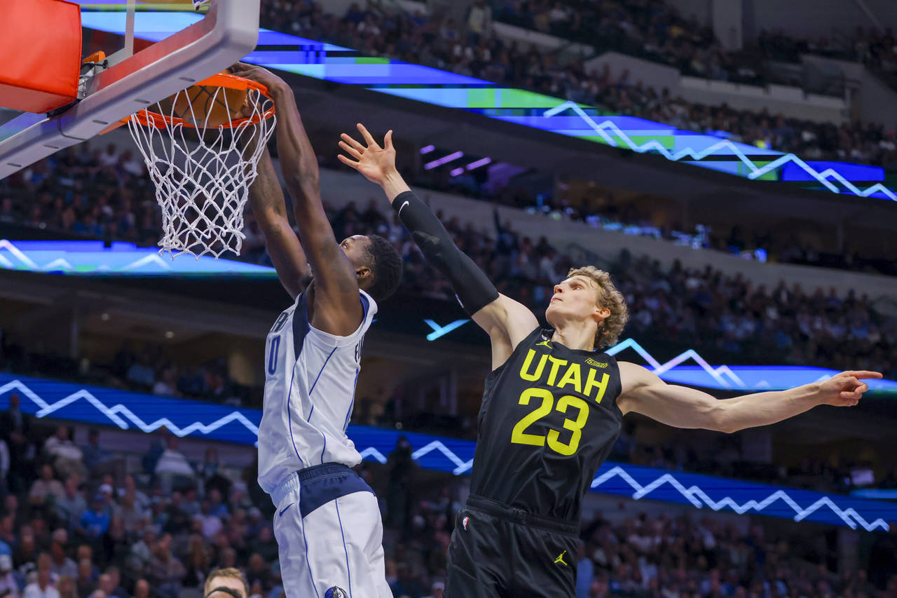 Dallas Mavericks forward Dorian Finney-Smith (10) dunks after driving past Utah Jazz forward Lauri ...