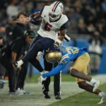 
              Arizona running back Michael Wiley escapes a tackle by UCLA defensive back Jaylin Davies during the first half of an NCAA college football game Saturday, Nov. 12, 2022, in Pasadena, Calif. (AP Photo/Mark J. Terrill)
            
