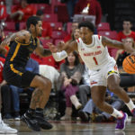 
              Maryland guard Jahmir Young (1) handles the ball against Coppin State guard Sam Sessoms during the first half of an NCAA basketball game, Friday, Nov. 25, 2022, in College Park, Md. (AP Photo/Terrance Williams)
            