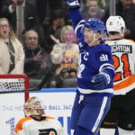 
              Toronto Maple Leafs' John Tavares (91) celebrates his third goal of the game against Philadelphia Flyers goaltender Felix Sandstrom (32) during the third period of an NHL hockey game in Toronto on Wednesday, Nov. 2, 2022. (Frank Gunn/The Canadian Press via AP)
            