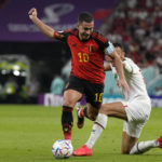 
              Morocco's Romain Saiss, right, fights for the ball with Belgium's Eden Hazard, during the World Cup group F soccer match between Belgium and Morocco, at the Al Thumama Stadium in Doha, Qatar, Sunday, Nov. 27, 2022. (AP Photo/Alessandra Tarantino)
            