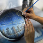 
              Paraguayan artist Lili Cantero hand-paints a soccer ball featuring the capital of Qatar, Doha, in San Lorenzo, Paraguay, Thursday, Nov. 10, 2022. Decoratively detailing the lavish stadiums of the upcoming tournament in Qatar — the first to take place in the Middle East — as well as the most sought after players and teams, Cantero is preparing the last details of her soccer-inspired art show, “8 Stadiums, 8 Champions, 1 Dream: Qatar 2022.” (AP Photo/Jorge Saenz)
            