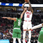 
              Chicago Bulls' DeMar DeRozan shoots over Boston Celtics' Derrick White during the second half of an NBA basketball game Monday, Oct. 24, 2022, in Chicago. The Bulls won 120-102. (AP Photo/Charles Rex Arbogast)
            