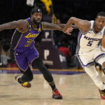 
              Sacramento Kings guard De'Aaron Fox, right, drives pas Los Angeles Lakers guard Patrick Beverley during the second half of an NBA basketball game Friday, Nov. 11, 2022, in Los Angeles. (AP Photo/Mark J. Terrill)
            