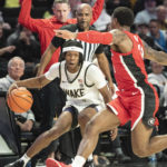 
              Wake Forest guard Tyree Appleby, front left, works around the defense of Georgia guard Justin Hill, right, in the first half of an NCAA college basketball game Friday, Nov. 11, 2022, in Winston-Salem, N.C. (Allison Lee Isley/The Winston-Salem Journal via AP)
            