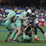 
              Herman Humwa of Kenya is tackled by Ireland team during the first day of the Hong Kong Sevens rugby tournament in Hong Kong, Friday, Nov. 4, 2022. The Hong Kong Sevens, a popular stop on the World Rugby Sevens Series circuit, is part of the government's drive to restore the city's image as a vibrant financial hub after it scrapped mandatory hotel quarantine for travelers. (AP Photo/Anthony Kwan)
            