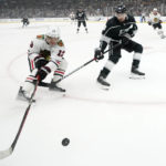 
              Chicago Blackhawks center Max Domi, left, and Los Angeles Kings defenseman Drew Doughty reach for the puck during the first period of an NHL hockey game Thursday, Nov. 10, 2022, in Los Angeles. (AP Photo/Mark J. Terrill)
            