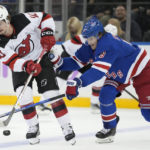 
              New Jersey Devils right wing Alexander Holtz (10) passes against New York Rangers defenseman Jacob Trouba (8) in the second period of an NHL hockey game, Monday, Nov. 28, 2022, in New York. (AP Photo/John Minchillo)
            