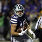 
              Kansas State tight end Sammy Wheeler (19) scores a touchdown during the first quarter of the team's NCAA college football game against Kansas on Saturday, Nov. 26, 2022, in Manhattan, Kan. (AP Photo/Colin E. Braley)
            