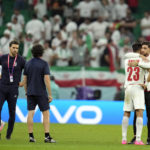 
              Iran's Ramin Rezaeian (23) is consoled after losing 1-0 to the United States in a World Cup group B soccer match between Iran and the United States at the Al Thumama Stadium in Doha, Qatar, Tuesday, Nov. 29, 2022. (AP Photo/Ashley Landis)
            